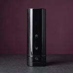 Kiiroo Onyx+ in Schwarz, aufrecht in der Mitte einer graphitgrauen Steinplatte